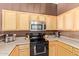 Well-equipped kitchen featuring wooden cabinets, modern appliances, and a functional layout for cooking and entertaining at 1350 S Greenfield Rd # 2205, Mesa, AZ 85206