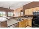 A closer view of the kitchen, featuring stainless steel sink and a view to the porch through the sliding glass door at 1350 S Greenfield Rd # 2205, Mesa, AZ 85206