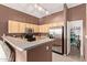 Open kitchen featuring stainless steel appliances, brown walls, and a view into a walk-in pantry at 1350 S Greenfield Rd # 2205, Mesa, AZ 85206