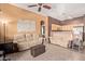 Inviting living room featuring tile flooring, neutral-toned sofas, and unique wall art, creating a cozy atmosphere at 1350 S Greenfield Rd # 2205, Mesa, AZ 85206
