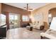 Inviting living room showcasing tile floors, sliding glass doors to the patio, and comfortable seating arrangements at 1350 S Greenfield Rd # 2205, Mesa, AZ 85206