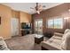Spacious living room with tile flooring, sliding glass doors to the patio, and neutral tones for versatile decor at 1350 S Greenfield Rd # 2205, Mesa, AZ 85206