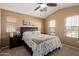 Comfortable bedroom with vaulted ceiling, plush carpet, a ceiling fan, and a large window providing natural light at 1350 S Greenfield Rd # 2205, Mesa, AZ 85206
