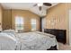 Bright main bedroom with neutral paint, a ceiling fan, and a door leading to the outside at 1350 S Greenfield Rd # 2205, Mesa, AZ 85206