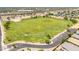 Aerial view highlights a large, grassy field ideal for sports and recreation, adding to the community's appeal at 1350 S Greenfield Rd # 2205, Mesa, AZ 85206