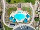 Aerial view of a large community pool with lounge seating and shade structures at 1350 S Greenfield Rd # 2205, Mesa, AZ 85206