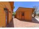 Backyard showcasing the house, a shed, a gate to the pool area, and landscaping at 1417 W Rose Ln, Phoenix, AZ 85013