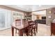 Inviting dining room featuring a wooden table, tile flooring, and natural light from the patio at 1417 W Rose Ln, Phoenix, AZ 85013