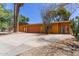 Home featuring a wide driveway leading to a two-car garage and a welcoming entrance at 1417 W Rose Ln, Phoenix, AZ 85013