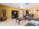 Warm living room with leather sofa, neutral tile flooring, and recessed lighting at 1417 W Rose Ln, Phoenix, AZ 85013