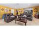 Open concept living room with neutral tile flooring and comfortable leather seating at 1417 W Rose Ln, Phoenix, AZ 85013