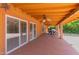 Covered patio with ceiling fan, brick columns, and a view of the backyard at 1417 W Rose Ln, Phoenix, AZ 85013