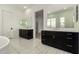 Bright, modern bathroom with dual vanities, white countertops, and stylish tile flooring, a perfect blend of comfort and design at 14177 W Calle Lejos --, Surprise, AZ 85387