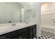 Modern bathroom with a double sink vanity, stylish backsplash, and tiled floors at 14177 W Calle Lejos --, Surprise, AZ 85387