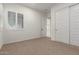 Well-lit bedroom with plantation shutters, a spacious closet, and neutral décor, providing a versatile and comfortable living space at 14177 W Calle Lejos --, Surprise, AZ 85387