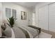 Bright bedroom featuring a window with plantation shutters, a cozy bed, and an adjacent bathroom at 14177 W Calle Lejos --, Surprise, AZ 85387