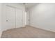 Bright bedroom features neutral carpet, double-door closet, and white walls at 14177 W Calle Lejos --, Surprise, AZ 85387