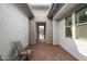Cozy courtyard featuring a brick floor, seating area, and entry to the home at 14177 W Calle Lejos --, Surprise, AZ 85387