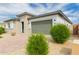 A single-Gathering home featuring desert landscaping and a two-car garage at 14177 W Calle Lejos --, Surprise, AZ 85387