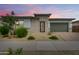Charming single-Gathering home featuring brick accents, a two-car garage, and desert landscaping at 14177 W Calle Lejos --, Surprise, AZ 85387