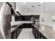 Well-appointed kitchen with stainless appliances, dark cabinets, and a granite-topped island with marble backsplash at 14177 W Calle Lejos --, Surprise, AZ 85387