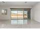 Bright living area with porcelain tile flooring, sliding glass doors and exterior access at 14177 W Calle Lejos --, Surprise, AZ 85387