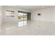 An open and airy living area featuring porcelain tile, recessed lights, and a sliding glass door at 14177 W Calle Lejos --, Surprise, AZ 85387