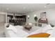 Bright, open-concept living room featuring modern decor, a spacious layout, and sleek tile flooring at 14177 W Calle Lejos --, Surprise, AZ 85387