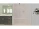 Contemporary shower with a built-in bench, sleek chrome fixtures, and a pristine white interior, offering a spa-like experience at 14177 W Calle Lejos --, Surprise, AZ 85387
