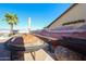 Backyard featuring a unique train track feature, desert landscape mural, palm tree, and clear blue sky at 14725 S 182Nd Dr, Goodyear, AZ 85338