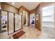 Bathroom with walk-in shower and doorway to walk-in closet at 14725 S 182Nd Dr, Goodyear, AZ 85338