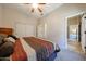 Bedroom with carpet flooring, a ceiling fan, and ample storage with sliding door closet at 14725 S 182Nd Dr, Goodyear, AZ 85338