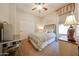 Charming bedroom featuring a ceiling fan, patterned bedding, and a metal bed frame at 14725 S 182Nd Dr, Goodyear, AZ 85338