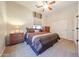 Cozy bedroom with a ceiling fan, carpet flooring, and closet for clothing storage at 14725 S 182Nd Dr, Goodyear, AZ 85338
