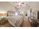 Cozy bedroom with carpet flooring, ceiling fan, and decor at 14725 S 182Nd Dr, Goodyear, AZ 85338