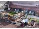 Outdoor train layout features a meticulously crafted miniature town with vintage cars at 14725 S 182Nd Dr, Goodyear, AZ 85338
