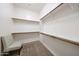 Spacious walk-in closet with ample shelving and a comfortable chair, perfect for organizing your wardrobe at 14725 S 182Nd Dr, Goodyear, AZ 85338