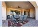 Outdoor patio features brick flooring, fan, dining table set, heater, and comfortable seating area at 14725 S 182Nd Dr, Goodyear, AZ 85338