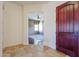 Inviting entryway featuring a decorative front door, tiled floors, and a view into the living area at 14725 S 182Nd Dr, Goodyear, AZ 85338