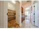 Hallway with travertine flooring, cabinets, and walk in pantry at 14725 S 182Nd Dr, Goodyear, AZ 85338