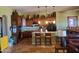 Well-lit kitchen featuring dark cabinets, granite countertops, a tile backsplash and travertine floors at 14725 S 182Nd Dr, Goodyear, AZ 85338