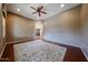Spacious living room featuring a ceiling fan, neutral walls, and dark hardwood floors with a decorative area rug at 14725 S 182Nd Dr, Goodyear, AZ 85338