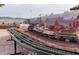 Outdoor train set includes a lumber train and a desert mountain backdrop at 14725 S 182Nd Dr, Goodyear, AZ 85338