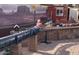 Backyard train set features a long passenger train traveling over a bridge structure at 14725 S 182Nd Dr, Goodyear, AZ 85338