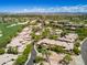 This aerial showcases the community's homes surrounded by lush landscaping, mature trees, and winding streets at 15240 N Clubgate Dr # 168, Scottsdale, AZ 85254