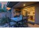 Covered patio with seating and dining, featuring a built-in grill and access to the indoor kitchen at 15240 N Clubgate Dr # 168, Scottsdale, AZ 85254