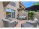 Spacious back patio with comfortable seating, shade umbrella, and partial view of home's exterior at 15240 N Clubgate Dr # 168, Scottsdale, AZ 85254