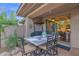 Covered patio with seating and dining, featuring a built-in grill and access to the indoor kitchen at 15240 N Clubgate Dr # 168, Scottsdale, AZ 85254
