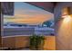Balcony sunset view with a potted plant and soft exterior light adding warmth at 15240 N Clubgate Dr # 168, Scottsdale, AZ 85254