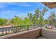 Balcony view overlooking lush desert landscaping with trees and cacti under a clear sky at 15240 N Clubgate Dr # 168, Scottsdale, AZ 85254